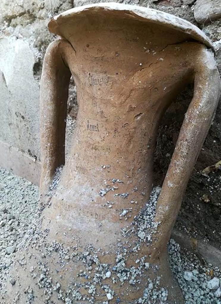 III.3.6 Pompeii. December 2017. Room in north-east corner with amphorae with inscription on neck.
Secondo il Parco Archeologico di Pompei, le anfore rinvenute intatte, dovevano contenere olio, vino e salse di pesce: un'anfora presenta iscrizioni dipinte in cui si leggono numeri, a indicare i quantitativi, e, verosimilmente, il prodotto contenuto. L'uso come deposito dell'ambiente è confermato dai graffiti visibili su una delle pareti dell'ambiente, che ribadiscono l'attività di stoccaggio.
According to the Parco Archeologico di Pompei, the amphorae found intact, had to contain oil, wine and fish sauce: This vase has painted inscriptions in which you can read numbers, to indicate the quantities, and, probably, the product contained. The use of the room as storage is confirmed by the graffiti visible on one of the walls of the room, which reiterate the activity of storage.
Photo © Parco Archeologico di Pompei.