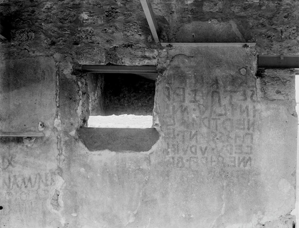 III.4.2 Pompeii. Undated photo, pre 1943. Remains of Oscan Eituns, to left of entrance. Foto Taylor Lauritsen, ERC Grant 681269 DÉCOR.
According to Garcia y Garcia, most damaging was the loss of the Oscan Eituns found in 1915 on the external wall to the left of the entrance doorway, because of the fall of the fragile plaster due to the bombardment in 1943.  
Both the houses at nos. 2 and 3 sustained severe bomb damage in September 1943, part of the west wall of the garden collapsed, ceilings and rooms on the upper storey were demolished, while wall paintings suffered heavily.
See Garcia y Garcia, L., 2006. Danni di guerra a Pompei. Rome: L’Erma di Bretschneider. (p.56-58 - 7 photos before & after the bombing, and after restoration, description of damage, p 56)