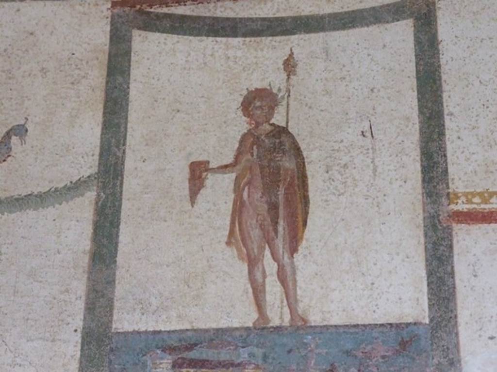 III.4.b Pompeii. March 2009. 
Room 4, upper north wall of anteroom/exedra. Painting of crowned figure with thyrsus and drinking horn.
According to Kuivalainen – 
“The pictorial programme as a whole and the posture of the youth support the identification as Bacchus, depicted half naked.”
See Kuivalainen, I., 2021. The Portrayal of Pompeian Bacchus. Commentationes Humanarum Litterarum 140. Helsinki: Finnish Society of Sciences and Letters, (p.94-95, B1).