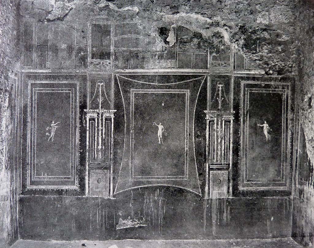 III.4.b Pompeii. Room 8, east wall of “yellow” oecus, this room may have been used to show and sell the jewellery/gems.
See Spinazzola, V. Pompei, alla luce degli Scavi Nuovi di Via dell’Abbondanza (Anni 1910-1923), Vol.2, (p.692, fig.656 and 657). 
According to Kuivalainen –
 “In the central panel, an almost naked Bacchus with thyrsus, depicted as a floating figure, larger than the floating figures on both side fields.
He gives special attention to the chalice which is quite rare.”
See Kuivalainen, I., 2021. The Portrayal of Pompeian Bacchus. Commentationes Humanarum Litterarum 140. Helsinki: Finnish Society of Sciences and Letters, (p.95-96, B2).