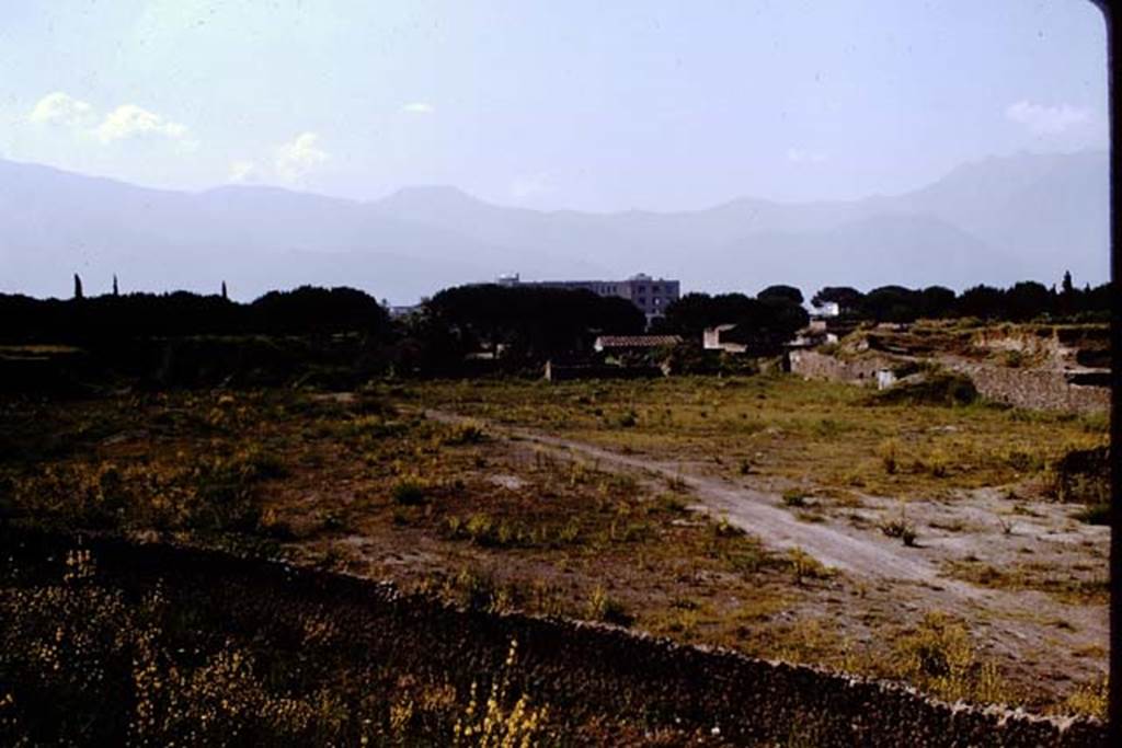III.7 Pompeii. 1964. Looking south-west across site towards II.4 from outside walls, near T7.   Photo by Stanley A. Jashemski.
Source: The Wilhelmina and Stanley A. Jashemski archive in the University of Maryland Library, Special Collections (See collection page) and made available under the Creative Commons Attribution-Non Commercial License v.4. See Licence and use details.
J64f2006