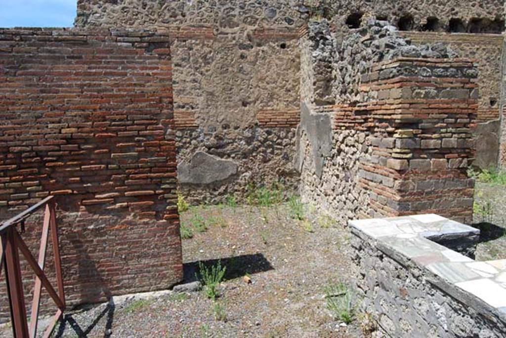 V.1.1 Pompeii. May 2013. Looking north from counter towards first rear room in north-west corner of bar-room, in centre. The window opening in its east wall is just visible, and the doorway to second room on north side can be seen on the right.  Photo courtesy of Paula Lock.