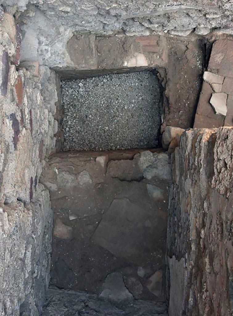 V.1.3 Pompeii. c.2008-10. 
Room “c”, flooring of latrine with doorway into outer area, on right. Photo by Hans Thorwid.
Photo courtesy of the Swedish Pompeii Project.