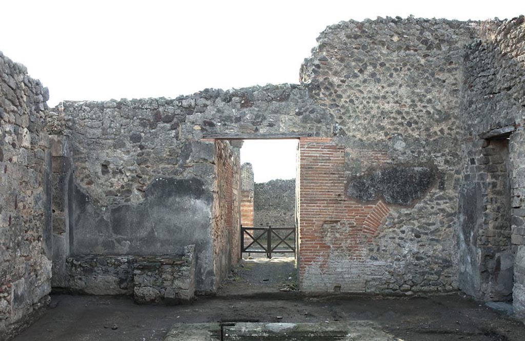 V.1.3 Pompeii. c c.2008-10. 
Room 2, south wall of atrium, with hearth on left, and entrance doorway onto Via di Nola, in centre. Photo by Hans Thorwid.
Photo courtesy of the Swedish Pompeii Project.