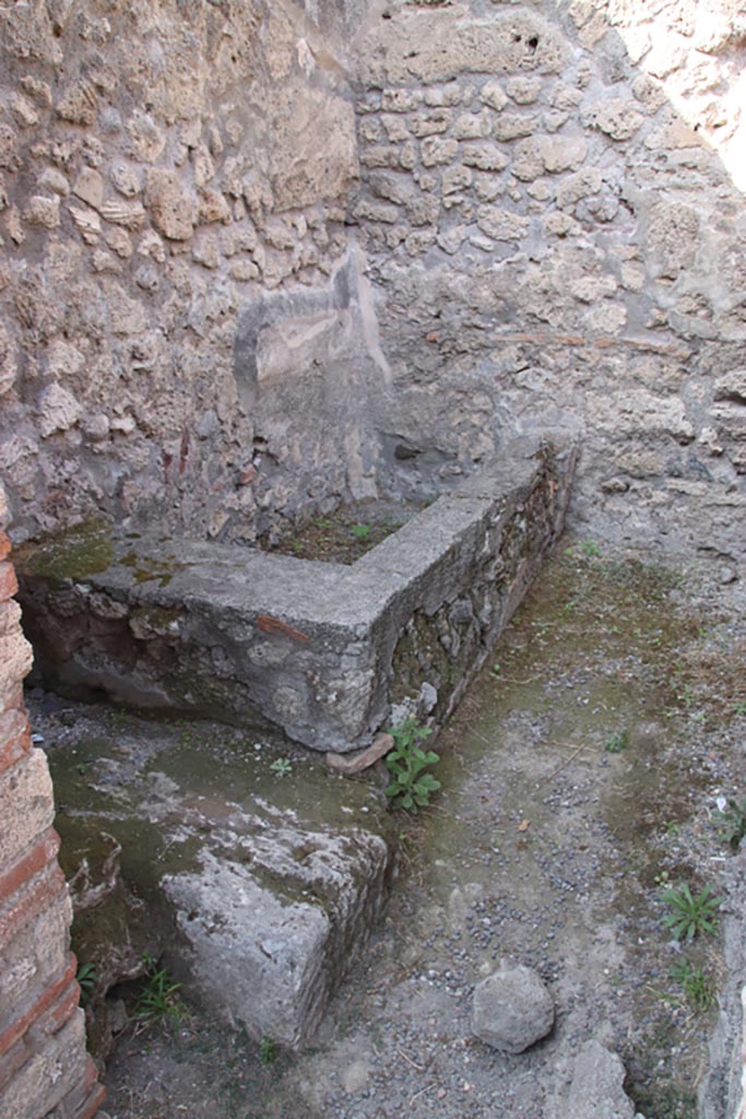 V.1.4 Pompeii. October 2023. 
Looking through doorway of rear room towards water basin. Photo courtesy of Klaus Heese.