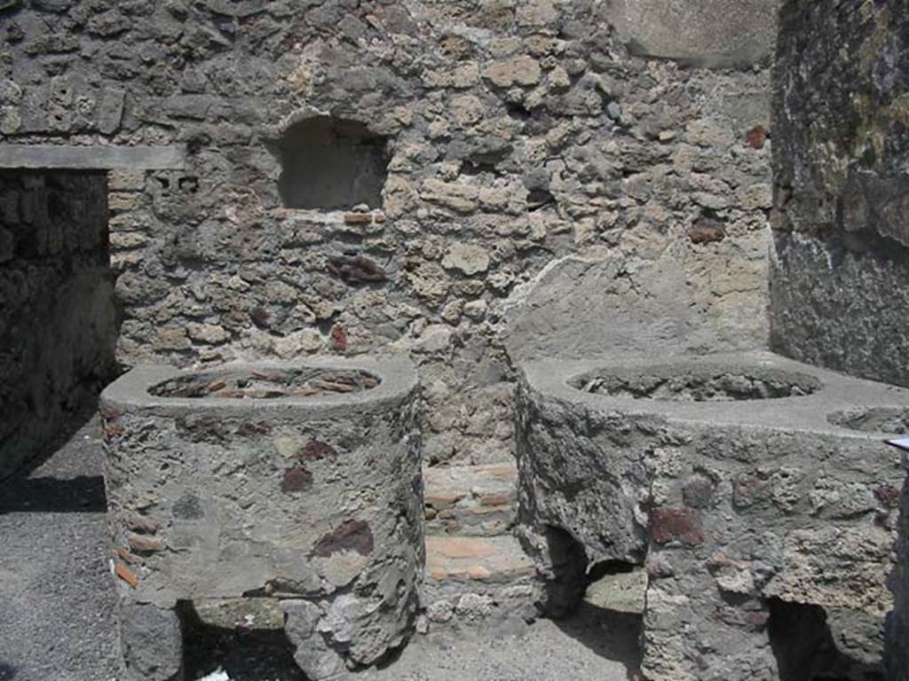 V.1.5 Pompeii. May 2003. Door to rear room in north wall with niche, and boilers or kettles nearby.  Photo courtesy of Nicolas Monteix.
