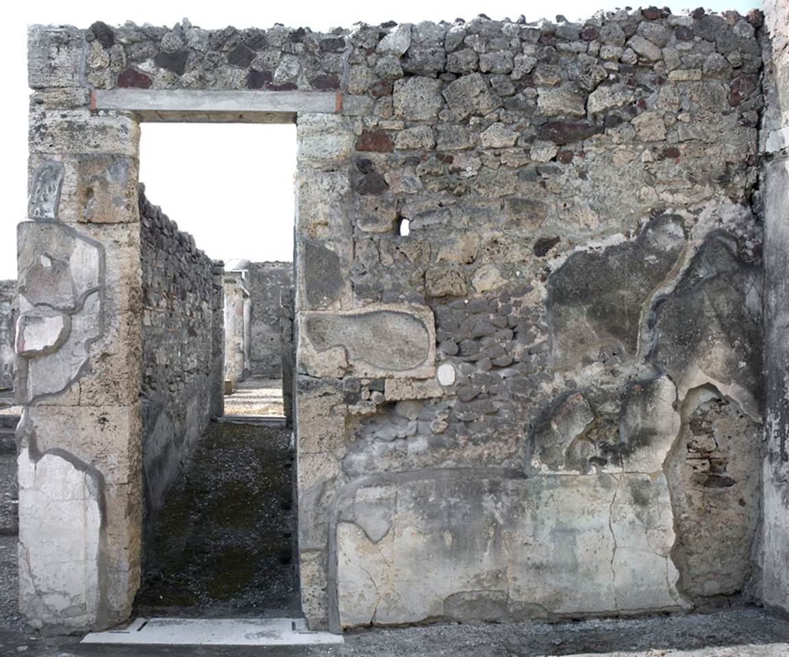 V.1.7 Pompeii. c.2005-7. 
Room 9, north wall of east ala, with doorway to corridor 10 leading to peristyle “b”.
Photo by Hans Thorwid. 
Photo courtesy of the Swedish Pompeii Project.