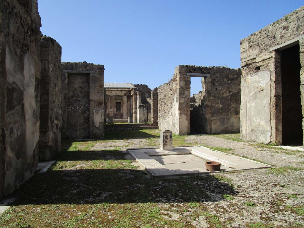 V.1.7, Pompeii. April 2019. 
Looking north across atrium 4 towards doorway to room 13 tablinum, room 10 corridor, room 9 east ala, and room 8 cubiculum.  
Photo courtesy of Rick Bauer.