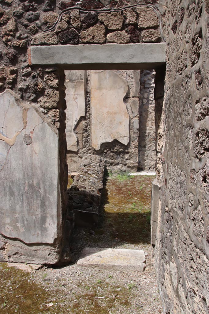 V.1.7 Pompeii. May 2024. 
Room 15, doorway into room 14 at east end of north wall. Photo courtesy of Klaus Heese.