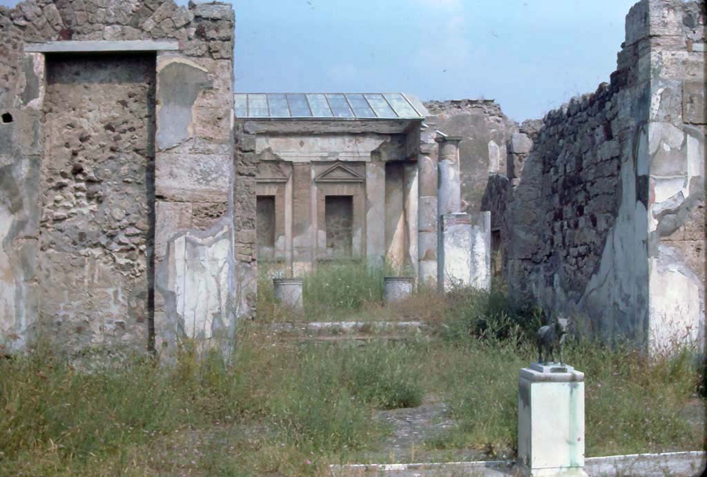 V.1.7 Pompeii, 7th August 1976. Room 1, looking from atrium with model of bull in situ, across tablinum to peristyle area.
Photo courtesy of Rick Bauer, from Dr George Fay’s slides collection.