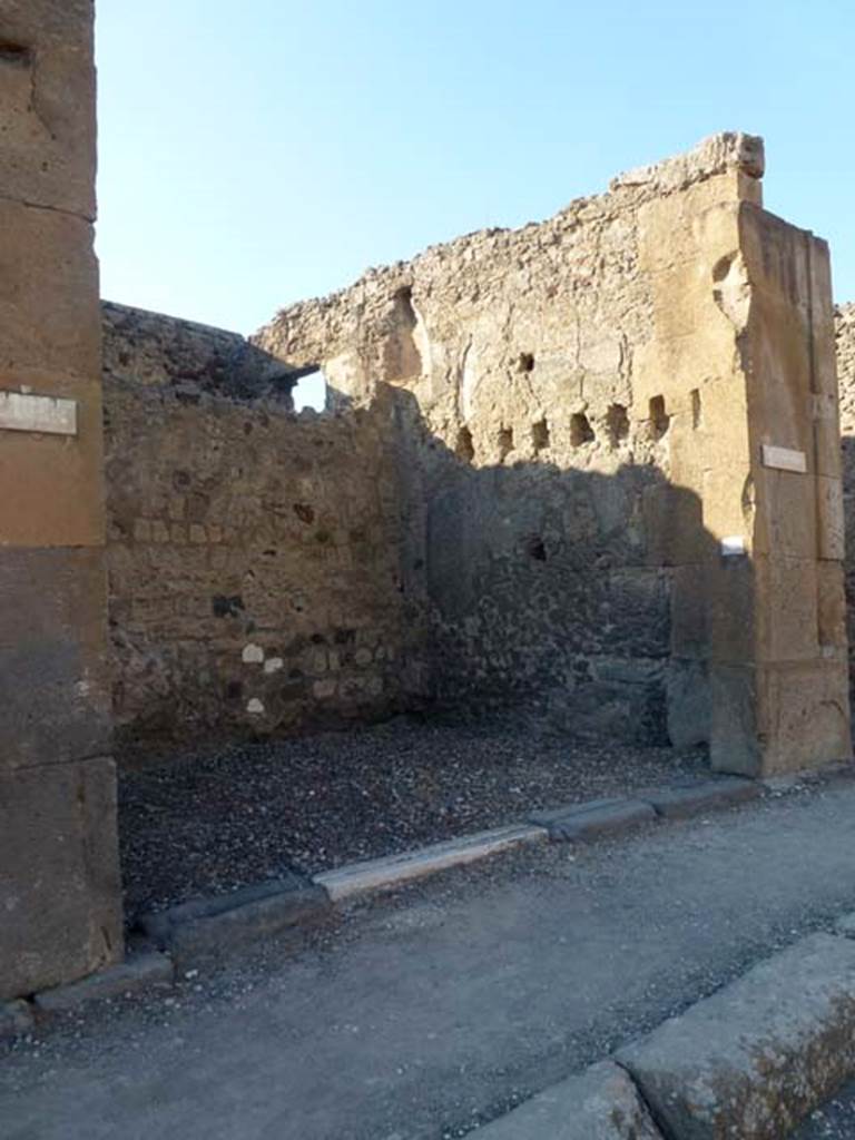 V.1.8 Pompeii. June 2012. Looking towards entrance doorway on north side of Via di Nola.
Photo courtesy of Michael Binns.
