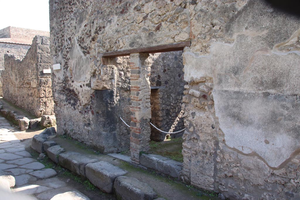 V.1.11 and V.1.12 Pompeii, in centre. October 2023. Looking south-east towards entrance doorways. Photo courtesy of Klaus Heese.