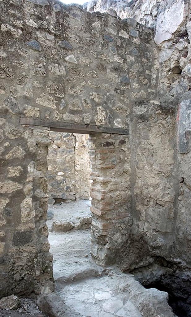V.1.11 Pompeii. c.2005-7? 
Room “z”, latrine, west wall with doorway into room “w” leading to entrance at V.1.11. Photo by Hans Thorwid.
Photo courtesy of The Swedish Pompeii Project.