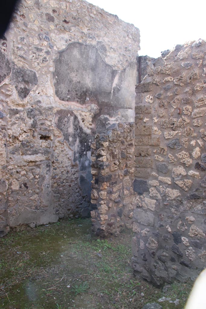 V.1.11 Pompeii. October 2023. 
Looking south-west from entrance doorway, towards doorway under stairs to upper floor.
At the rear is the corridor, leading west. Photo courtesy of Klaus Heese.