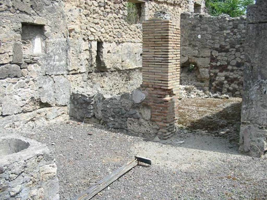V.1.13 Pompeii. May 2003. Looking north-east from counter towards doorway to rear room and window overlooking front-room. 
The rear room had a recess for a couch extending for almost the entire length of the north wall. Photo courtesy of Nicolas Monteix.