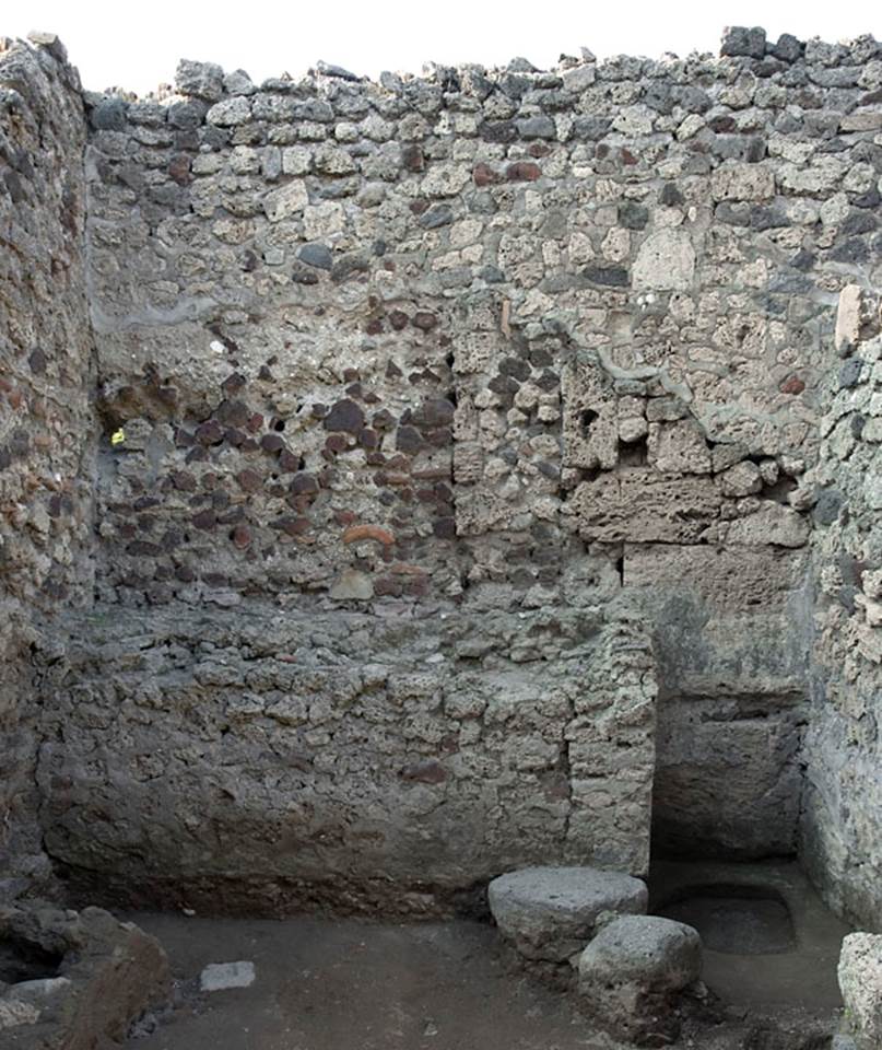 V.1.13 Pompeii. Pre-2008. 
Hearth built against north wall of rear room “f”, with well in north-east corner. 
Photo by Hans Thorwid. 
“The rear room in the caupona, room f, has a large hearth built against the N wall, and two roughly built supports for a table along the E wall.”
Photo and words courtesy of the Swedish Pompeii Project.