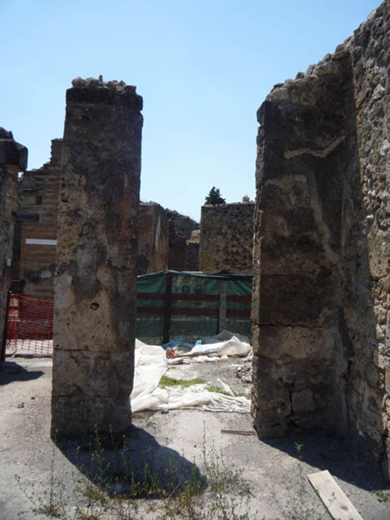 V.1.15 Pompeii. July 2008. North-west corner of atrium with doorway to V.1.14, on right. Photo courtesy of Jared Benton.