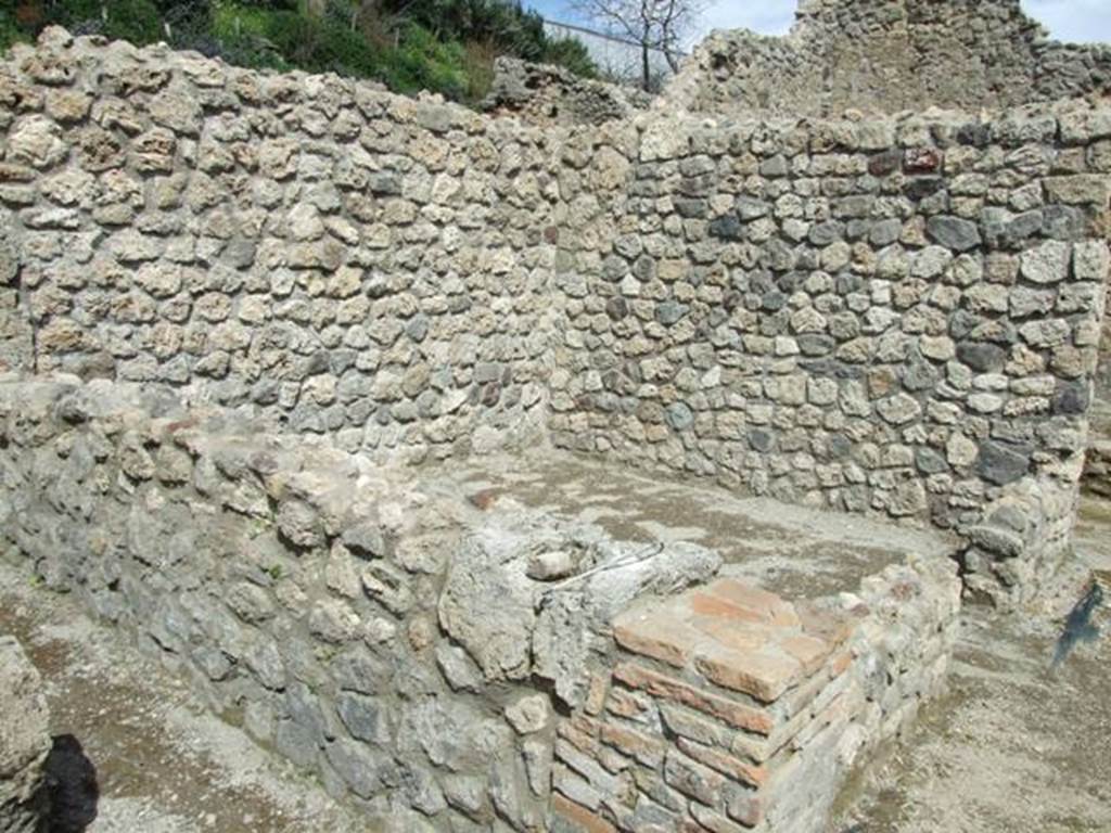 V.1.15 Pompeii. April 2009. Looking north-east towards room in bakery on north side.
According to CTP in 1986,  “This pistrinum was severely damaged by bombs during the bombing of September 1943. The whole north-east portion was destroyed. One bomb partially broke up the roadway in front of the street entrance. This has now been restored in part, whereas the four rooms to the north-east and part of the north perimetral wall have not yet been restored.”
See Van der Poel, H. B., 1986. Corpus Topographicum Pompeianum, Part IIIA. Austin: University of Texas. (p.70)