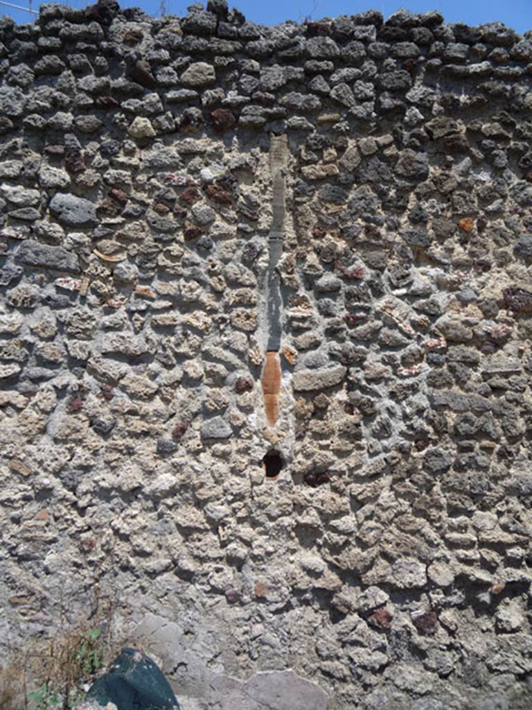 V.1.15 Pompeii. July 2008.  East wall of garden area with downpipe embedded in wall.
Photo courtesy of Jared Benton.