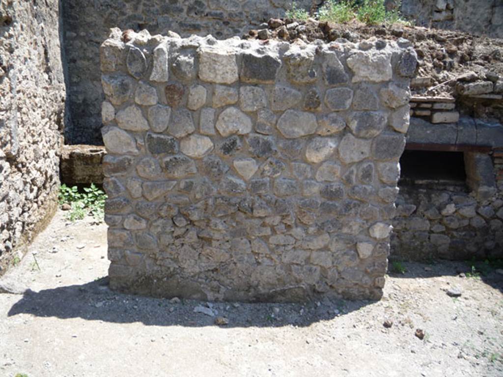 V.1.15 Pompeii. July 2008. Looking south at east end of oven.
The doorway to the kitchen and latrine in the south-east corner of the bakery is on the left. Photo courtesy of Jared Benton.