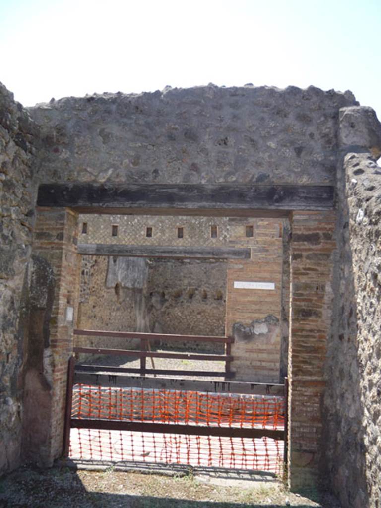 V.1.16 Pompeii. July 2008. West wall with entrance doorway onto Via del Vesuvio.
Photo courtesy of Jared Benton.