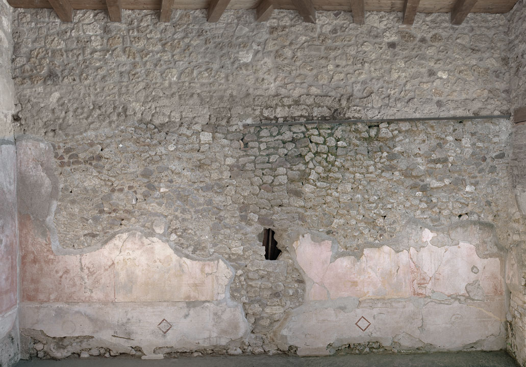V.1.18 Pompeii. 2012. Room “p”, oecus, east wall. Photo by Hans Thorwid.
“East wall in 2012. 
Restored parts of the wall photographed and merge with the lower part and floor line of earlier photos from 2005-07.”
Photo and words courtesy of The Swedish Pompeii Project.
According to Schefold –
On the east (right) wall was a painting of Polyphemus and Galatea.
See Schefold, K., 1957. Die Wände Pompejis. Berlin: De Gruyter. p. 65.
