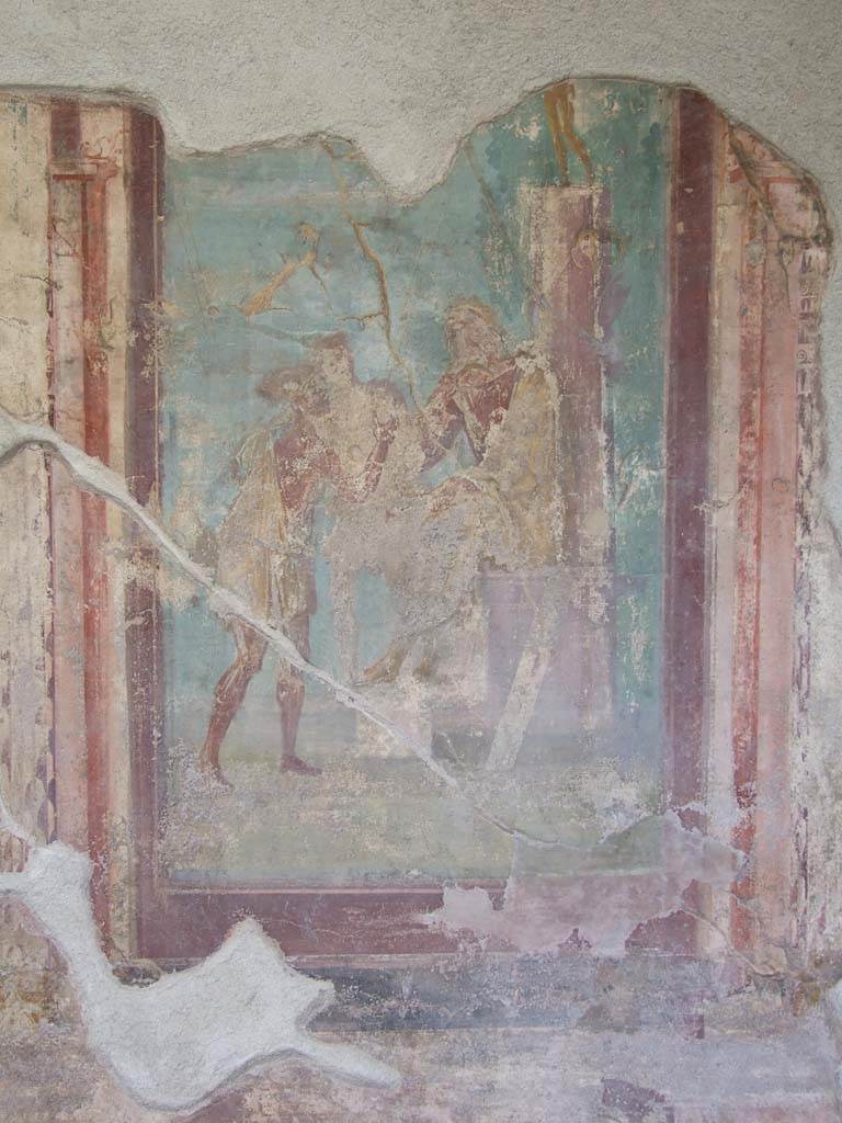 V.1.18 Pompeii. March 2009. 
North wall of exedra “y”. Wall painting of The Two Fishermen Proposing a Riddle to Homer.
Homer is seated on a throne with his feet resting on a stool.
Behind him is a pillar with a gilded bronze statue on top.
On the pillar are a shield and oar, symbols of the Iliad and the Odyssey.
Further back is a ship.
In front of the poet stand two fishermen, speaking to him.
See Leach, E.W., 2004. The Social Life of Painting in Ancient Rome and on the Bay of Naples. Cambridge UK: Cambridge UP. (p.135).