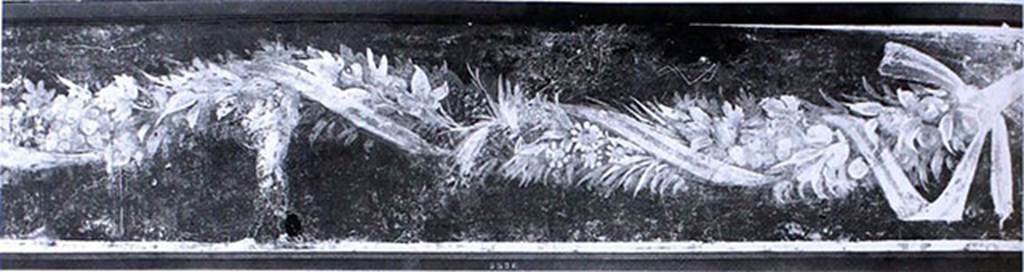 V.1.18 Pompeii. Old undated photograph. Tablinum “g”, south wall. Fresco with ribbon wound in a garland and cupid.
Now in Naples Archaeological Museum. Inventory number 8526.
