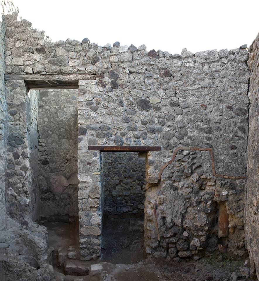 V.1.20 Pompeii. Pre-2008.  Room “d”.
East wall of kitchen.  Photo by Hans Thorwid. 
Photo courtesy of The Swedish Pompeii Project.
The tall doorway, possibly into a light-well,  and doorway into rear room in south-east corner.