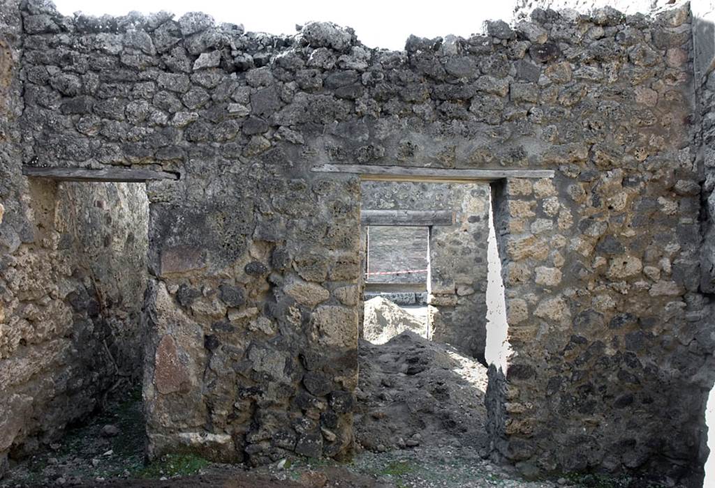 V.1.20 Pompeii. Pre 2008.  Room “d”. Photo by Hans Thorwid.
West wall of kitchen, with doorway to corridor, on left, and into rear room of shop-room, on right.  
Photo courtesy of The Swedish Pompeii Project.
