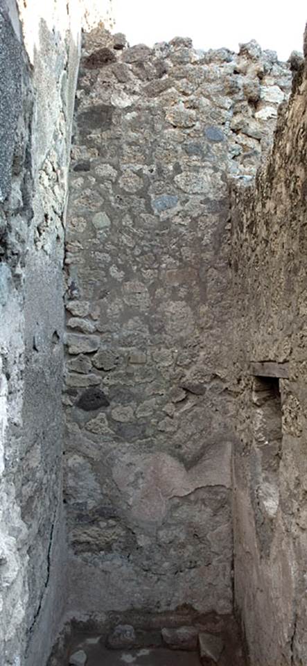 V.1.20 Pompeii. 2005. Room “f”. Photo by Hans Thorwid.
East wall of room with tall doorway in east wall of kitchen.  
Photo courtesy of The Swedish Pompeii Project.