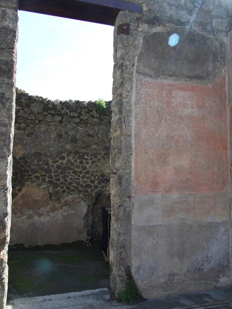 V.1.26 Pompeii. March 2009. Room “f”, doorway in south wall of atrium. 
According to Niccolini, on the walls of the atrium in the south-west corner were two paintings.
On the west wall was a painting of Ulysses and Penelope.
On the south wall, above on the right of the doorway, was a theatrical scene.
See Niccolini F, 1890. Le case ed i monumenti di Pompei: Volume Terzo. Napoli.
