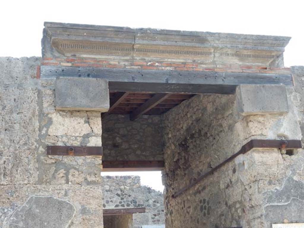 V.1.26 Pompeii. May 2015. Detail from upper entrance doorway. Photo courtesy of Buzz Ferebee.