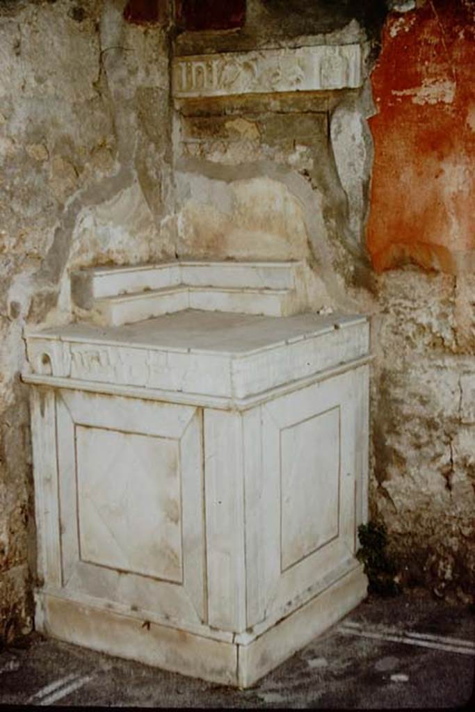 V.I.26 Pompeii. 1957. 
Room “b”, marble lararium in north-west corner of atrium. Photo by Stanley A. Jashemski.
Source: The Wilhelmina and Stanley A. Jashemski archive in the University of Maryland Library, Special Collections (See collection page) and made available under the Creative Commons Attribution-Non-Commercial License v.4. See Licence and use details.
J57f0414