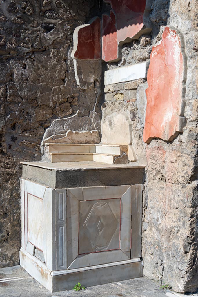 V.1.26 Pompeii. October 2023. 
Looking towards base of altar on east side. Photo courtesy of Johannes Eber.
