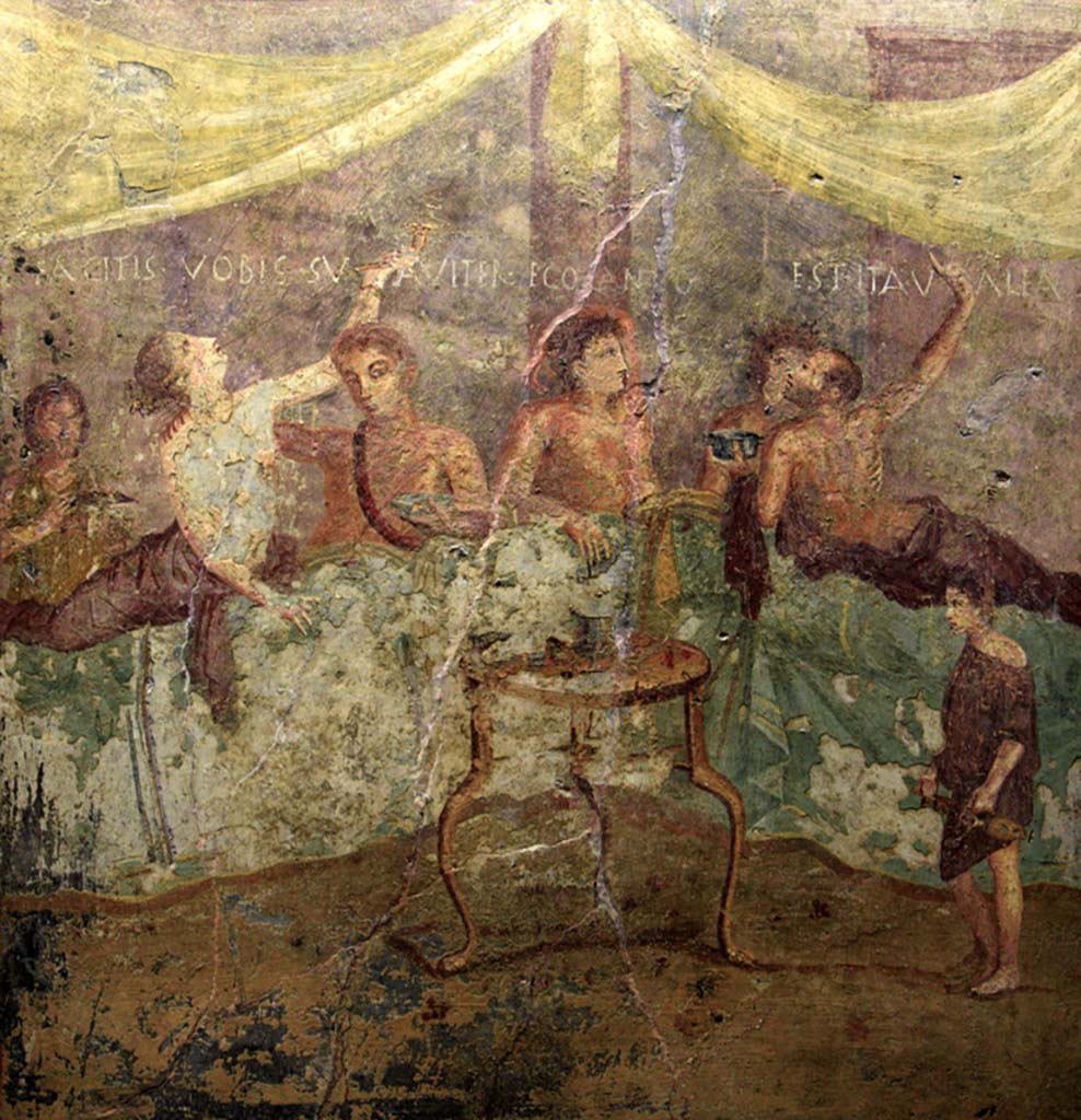 V.2.4 Pompeii. June 2017. Room 15, painting of banqueting scene from north wall of triclinium showing the Commencement. 
The guests are reclining at table and a boy brings in dishes. Photo courtesy of Johannes Eber.