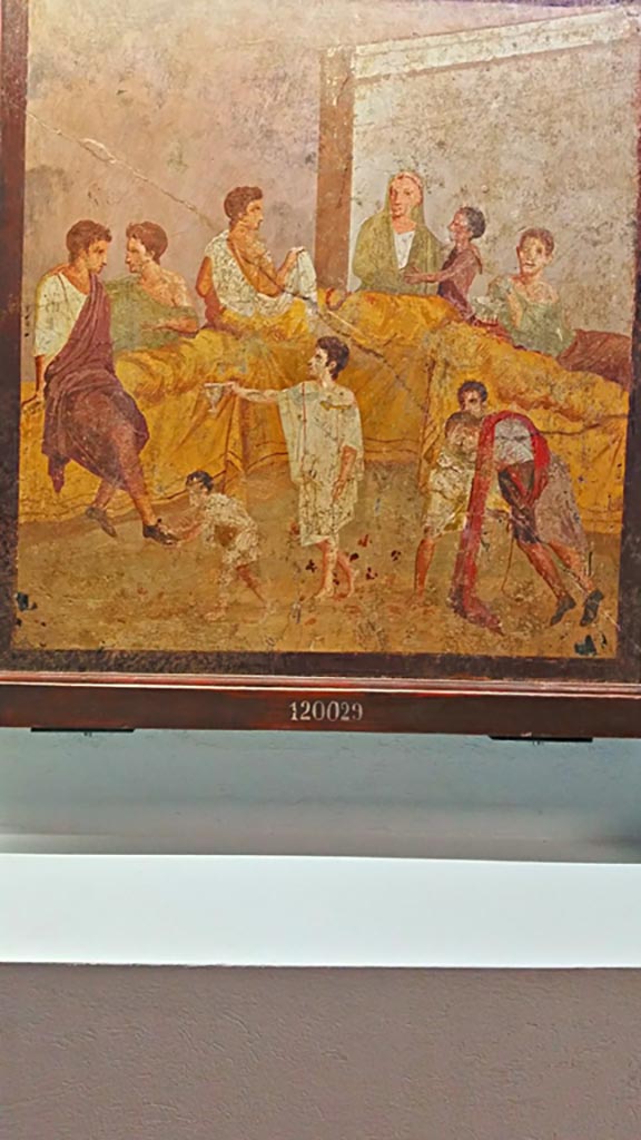 V.2.4 Pompeii. Room 15, painting of banqueting scene from east wall of triclinium.
On display in Naples Archaeological Museum, inv. 120029.
Photo courtesy of Giuseppe Ciaramella, June 2017.