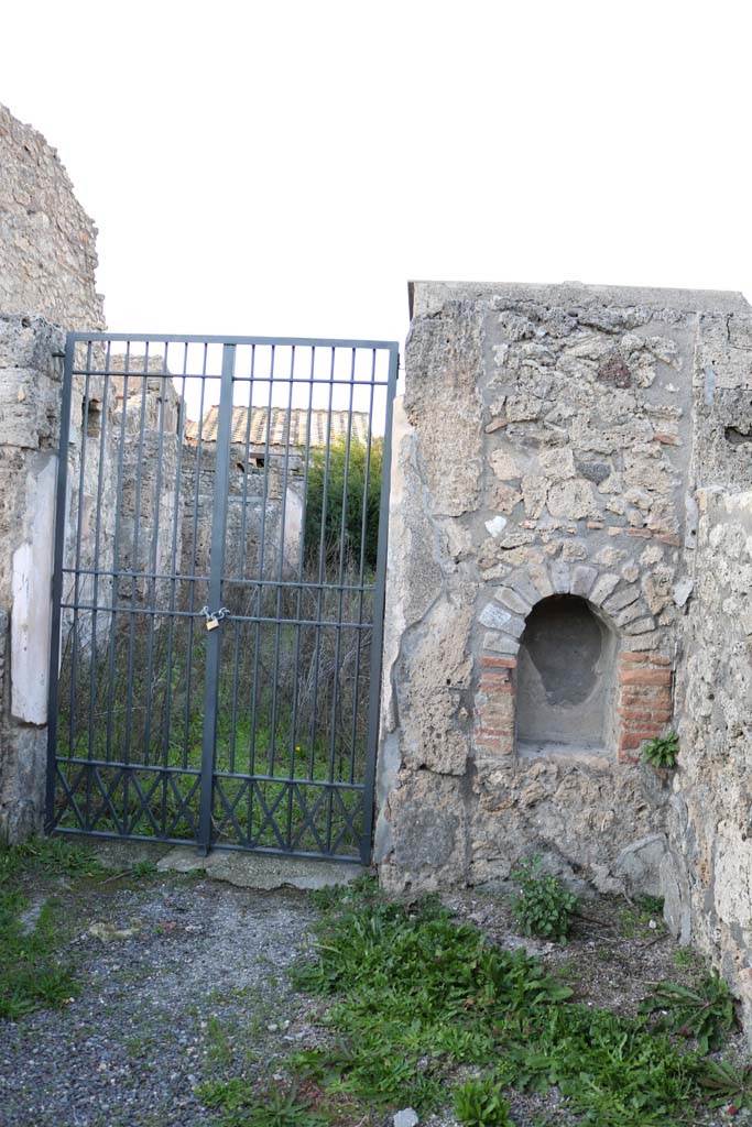 V.2.4, Pompeii. December 2018. 
Looking north to doorway with arched niche on east side. Photo courtesy of Aude Durand.