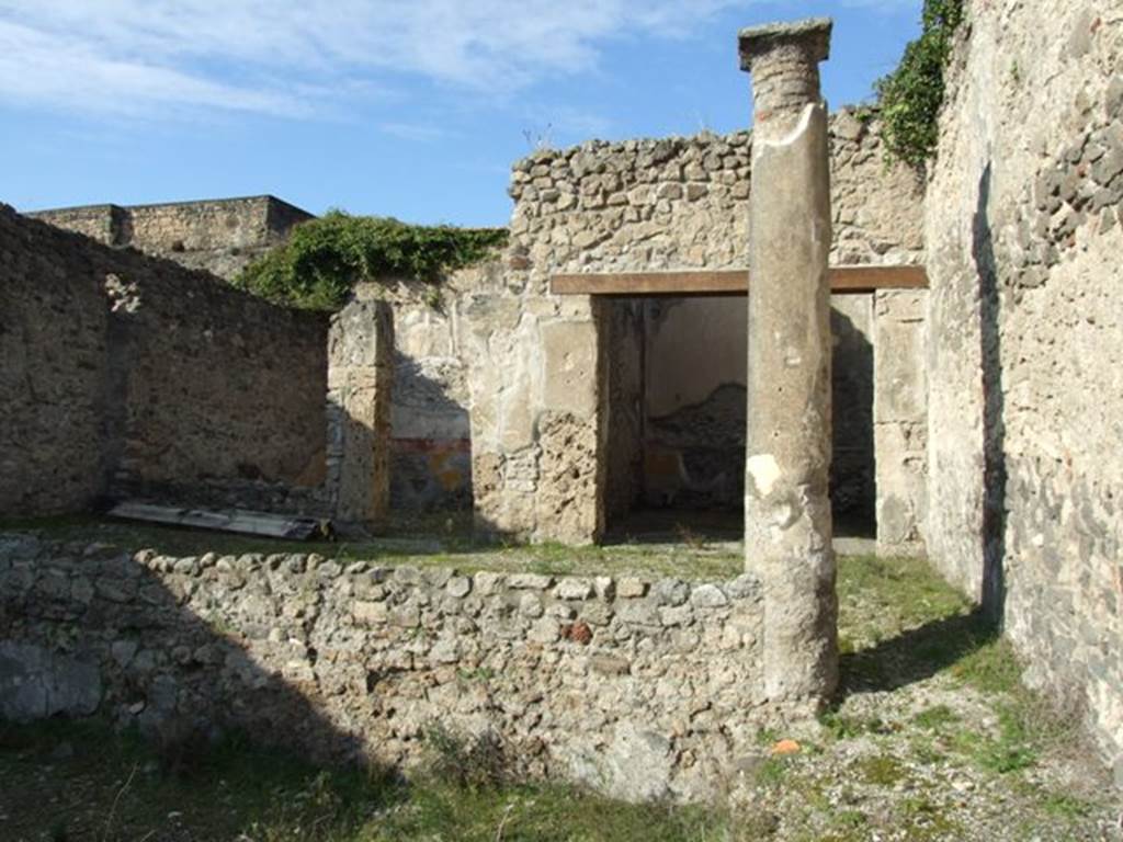 V.2.10 Pompeii. December 2007. Looking north in peristyle towards two doorways under the north portico. 
Doorway to room 11 on right, and room 12 on left.
According to Mau –
“The First style decoration was conserved in both rooms 11 and 12. The simplicity of this decoration – yellow zoccolo, red frieze, then white stucco – in the two most spacious rooms of the house, triclinia without doubt, demonstrated that it was inhabited at that time by people of modest means”.
See Mau in BdI, 1894, p.43.
