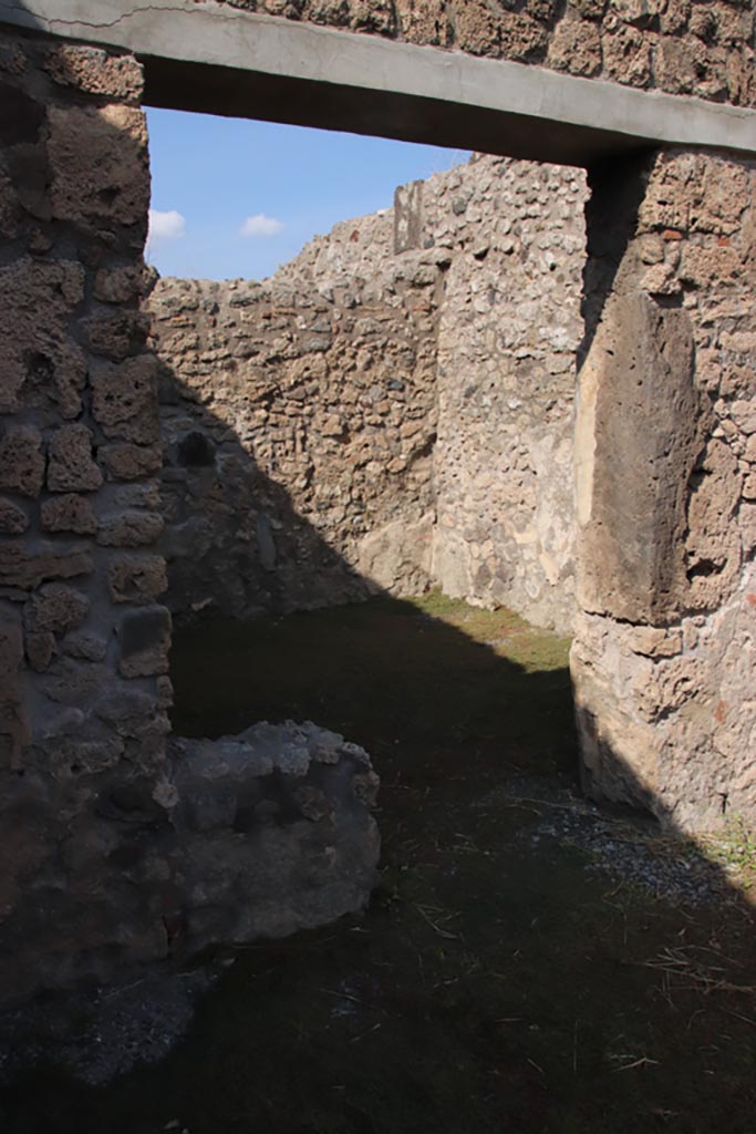 V.2.13 Pompeii. October 2022. 
Looking north-east through doorway of rear room in north wall of bar-room. Photo courtesy of Klaus Heese.