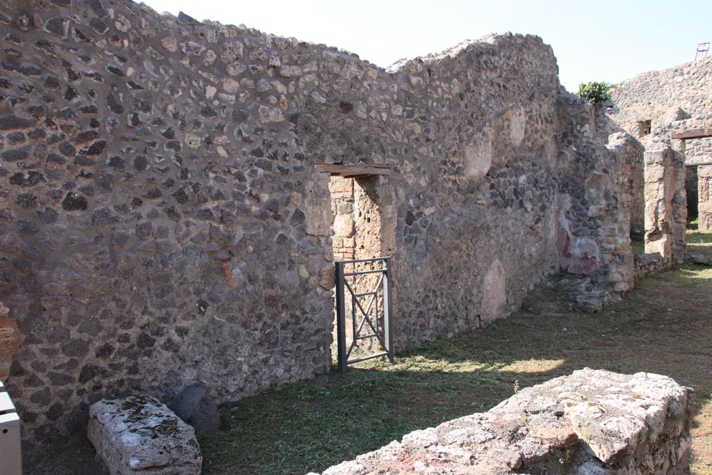 V.2.19 Pompeii. October 2022. 
Looking towards west wall, with base of steps to upper floor at V.2.18, on left. Photo courtesy of Klaus Heese.