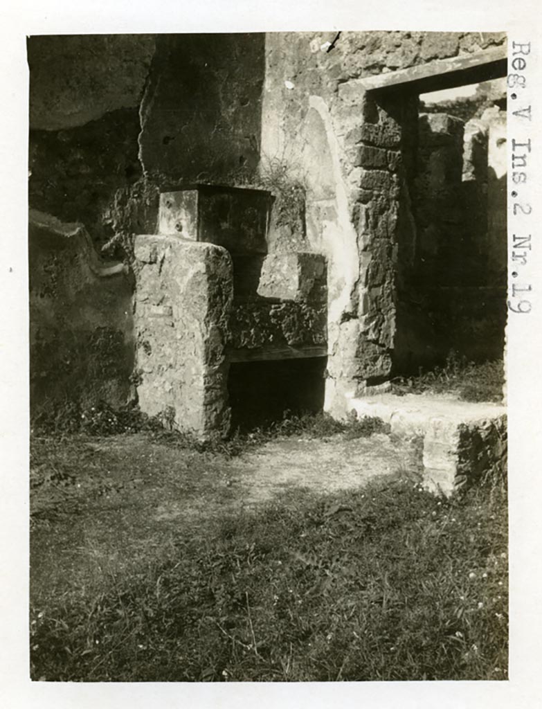 V.2.19 Pompeii. Pre-1937-39. North-west corner of thermopolium with hearth, and doorway to rear room, on right.  
Photo courtesy of American Academy in Rome, Photographic Archive. Warsher collection no. 1256.
