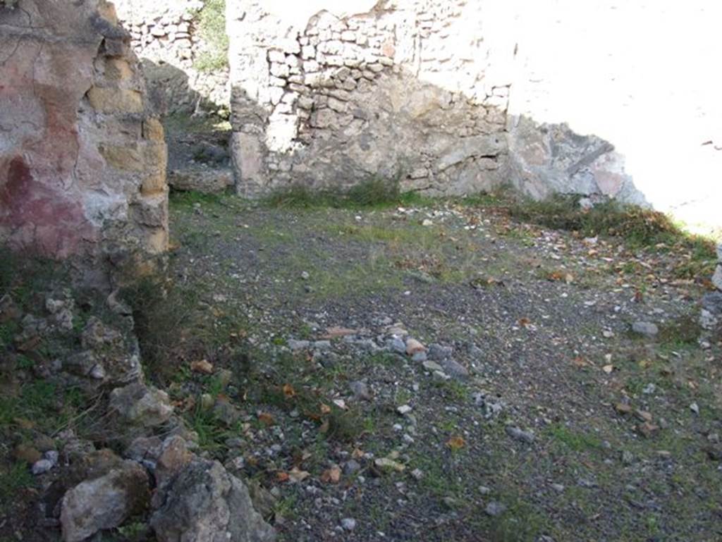 V.2.19 Pompeii. December 2007.  Site of doorway to rear room in north wall of thermopolium (across centre of photo).  According to Boyce, at the rear of the second room on the east side was an arched structure. Boyce said according to Mau, this may have been a lararium or merely a hearth.
See Boyce G. K., 1937. Corpus of the Lararia of Pompeii. Rome: MAAR 14. (p.35, no.98)
Boyce gives the reference Rom.Mitt., ix, 1894, 58.