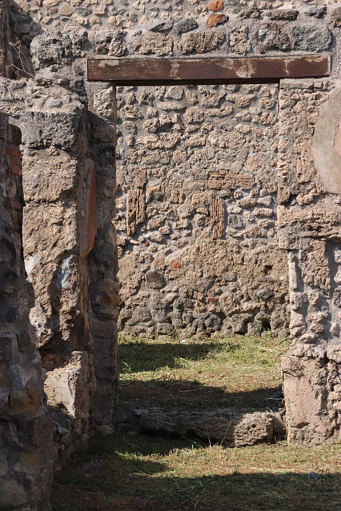 V.2.19 Pompeii. October 2022. 
Looking through linking doorway in north wall of rear room, looking north to light-yard of V.2.20.  
On the left is the window from the small room, to the rear of V.2.17.  Photo courtesy of Klaus Heese.