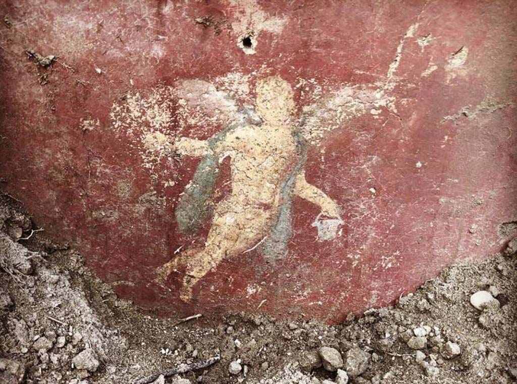 V.2.21 Pompeii. August 2018. Room A9 (as shown on PAP plan), painting of winged cupid at south end of west wall.
Photograph © Parco Archeologico di Pompei.
