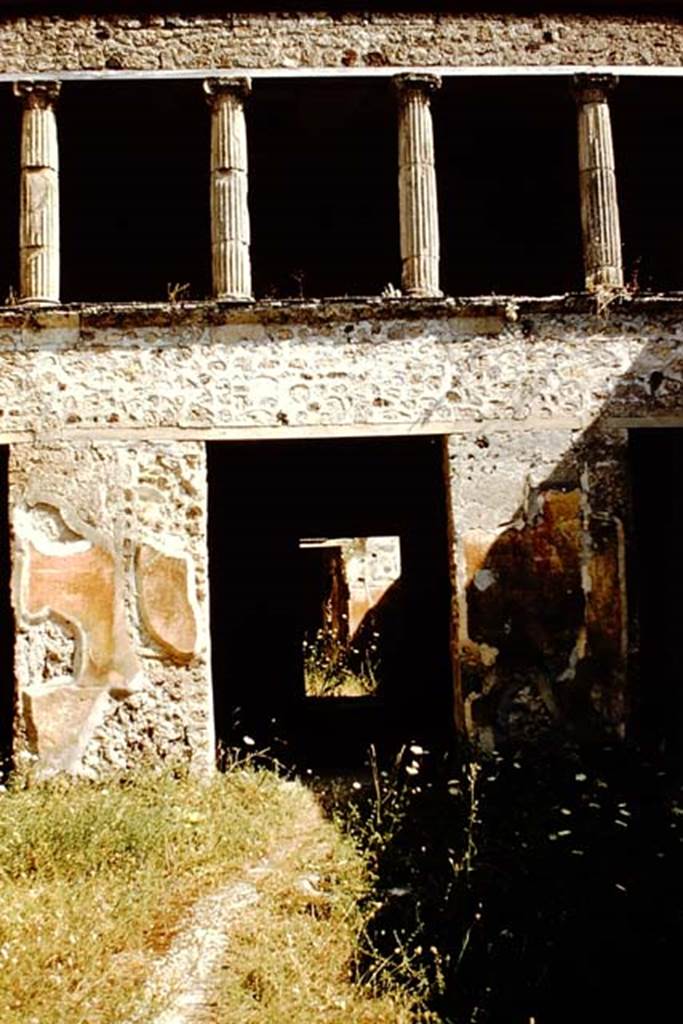 V.2.h Pompeii. 1959. South side of atrium, with doorway to tablinum ‘f’. 
At the rear of the tablinum (f), a decorated wall in room (h) can be seen. Photo by Stanley A. Jashemski.
Source: The Wilhelmina and Stanley A. Jashemski archive in the University of Maryland Library, Special Collections (See collection page) and made available under the Creative Commons Attribution-Non Commercial License v.4. See Licence and use details.
J59f0445