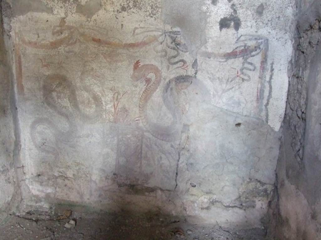 V.2.i Pompeii. March 2009. Room 26, lararium painting on west wall.  Two serpents approaching a round altar painted in a marble pattern, with a fire and a pine cone on the top. Above is a triple garland below which is a single bird in flight. See Boyce G. K., 1937. Corpus of the Lararia of Pompeii. Rome: MAAR 14.  (p.38, no.110 and Pl. 28,2)
See Fröhlich, T., 1991. Lararien und Fassadenbilder in den Vesuvstädten. Mainz: von Zabern. (L49).