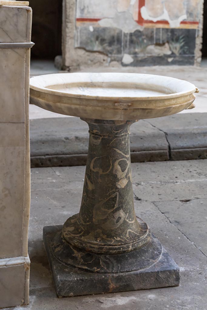 V.2.i Pompeii. March 2023. 
Room 1, atrium, south end of impluvium, detail of basin on a stand. Photo courtesy of Johannes Eber.