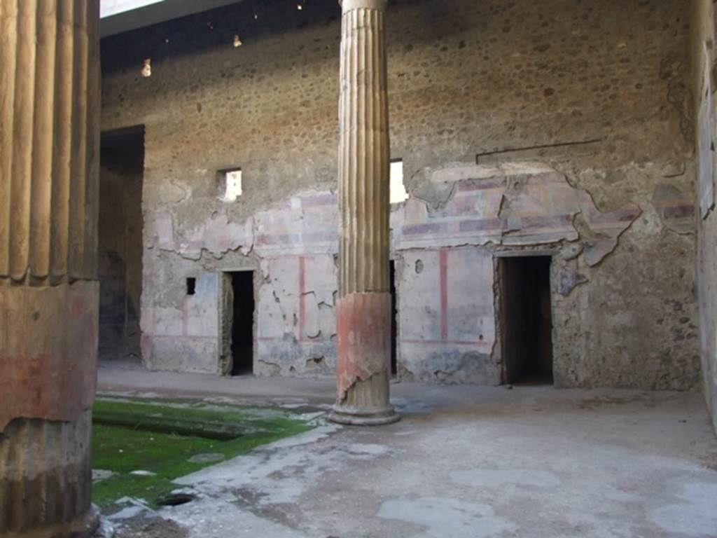 V.2.i Pompeii. December 2007. 
Looking south-west towards west side of atrium and windows of rooms in upper floor. On the left is room 8, west ala.