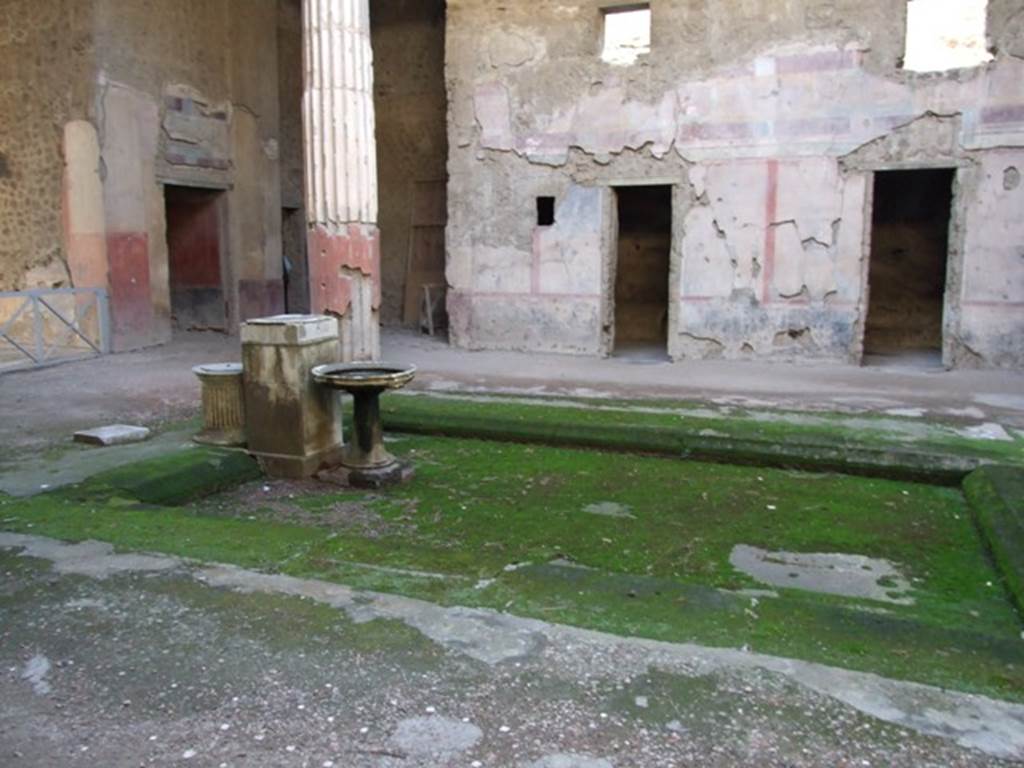 V.2.i Pompeii. December 2007. 
Room 1, looking south-west across the impluvium to west wall of atrium, on right. 
The doorway to corridor 10 is on the left with doorway to room 9 in south wall of ala 8, behind column.